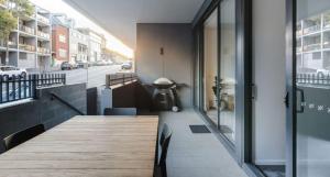 a room with a wooden table and a view of a street at The Muse in Newcastle +5 photos