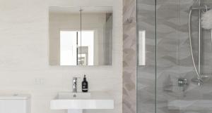 a white bathroom with a sink and a shower at The Outlook in Newcastle +8 photos