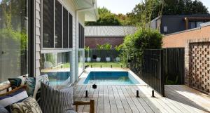 a backyard with a swimming pool and a fence at The Willows in Wickham