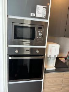 a microwave oven sitting inside of a kitchen at INAP DESA EVO BANGI in Bandar Baru Bangi