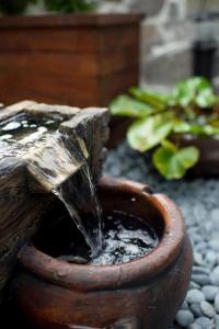 a small water fountain in a clay pot at Cherry Feast Resort in Yuchi