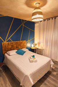 a bedroom with a bed with towels on it at Vieques Tropical Guest House in Vieques