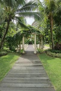 a walkway with palm trees in a park at Carnelian Tower - Sea View FC4219 in Gelang Patah