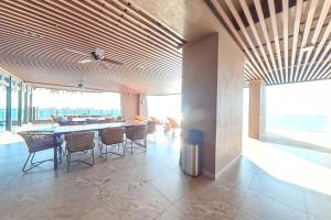 a dining room with a table and chairs in a building at Carnelian Tower - Sea View FC4219 in Gelang Patah