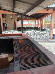 einem Metallgrill in der Mitte einer Terrasse in der Unterkunft Villas Norita in Ibarra