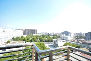 a balcony with a view of a city at Residence Hotel Hakata 8 in Fukuoka