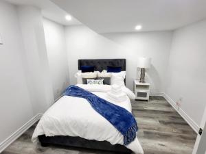 a bedroom with a large bed with blue and white sheets at Feel Like Home/ Bs Mississauga in Mississauga