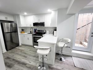 a kitchen with white cabinets and white counter tops at Feel Like Home/ Bs Mississauga in Mississauga