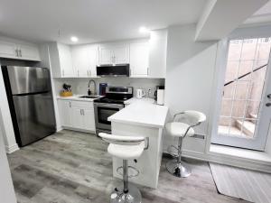 a kitchen with white cabinets and white counter tops at Feel Like Home/ Bs Mississauga in Mississauga +2 photos