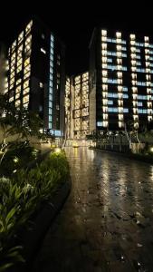 a city lit up at night with tall buildings at Monochromic Studio Apartment by Kinasih Suites in Kejayan