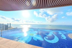 a swimming pool with a view of the ocean at Carnelian Tower - Forest City FC4223 in Gelang Patah