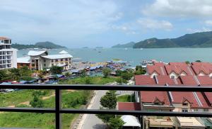 a view of a city and the water from a balcony at Bayu Apartment Services in Kuah