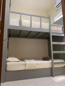 a bunk bed room with two bunk beds at Bayu Apartment Services in Kuah