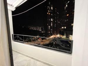 a window with a view of a city at night at Apartamento in Sabaneta