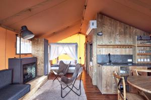 a living room with a fireplace in a tiny house at NRMA Merimbula Beach Holiday Resort in Merimbula