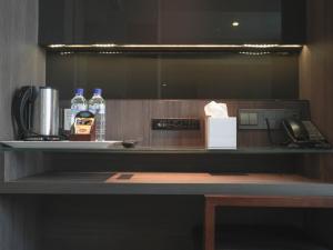 a counter with two bottles of water and a telephone at Amrise Hotel Kitchener in Singapore