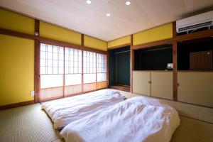 a large room with two beds in it with a window at 三津ミーツ in Mitsuhama