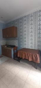 a room with a bed and a piano in it at VILLA INTAN PALEMBANG in Talangbetutu