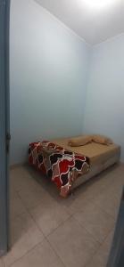 a bed sitting in a corner of a room at VILLA INTAN PALEMBANG in Talangbetutu