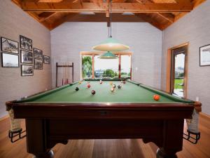 a pool table with balls on it in a room at Kumiko's Guest House in Omihi