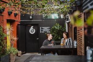 two women sitting at a table with drinks at Six Degrees Boutique Hotel in Albany