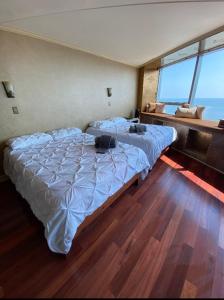 a bedroom with two beds and a large window at Beach Front with Ocean View in Atlantic City
