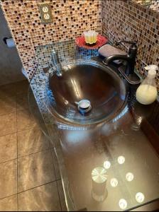 a bathroom with a sink with water in it at Beach Front with Ocean View in Atlantic City +1 photo