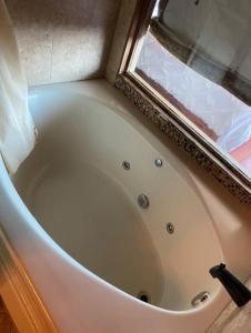 a white bath tub in a bathroom with a window at Beach Front with Ocean View in Atlantic City