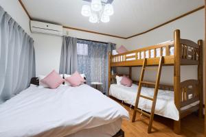 two beds in a room with two bunk beds at Morden stylish villa--Max12p--2Bathrooms--Free wifi in Tokyo