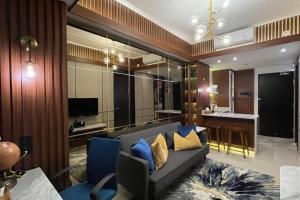 ein Wohnzimmer mit einem Sofa und blauen Stühlen in der Unterkunft The Best Merapi View Apartment By Kinasih Suites in Ngaglik