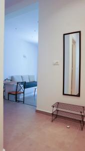a room with a bench and a mirror on a wall at ΟTTO apts in Loutrá