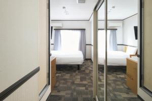 东京浅草筑波快速船舶酒店(Vessel Inn Asakusa Tsukuba Express)房間的床