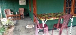 a room with two chairs and a table and a table and chairs at Green House Yala in Kirinda