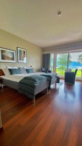 a large bedroom with two beds and a large window at Rosendal Fjordhotel in Rosendal