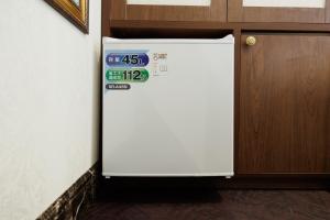 a white refrigerator in a room next to a door at Hotaku HOTEL - Vacation STAY 98852v in Tokyo