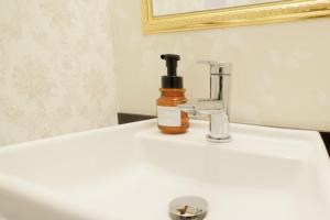 a bottle of soap sitting on top of a bathroom sink at Hotaku HOTEL - Vacation STAY 98852v in Tokyo