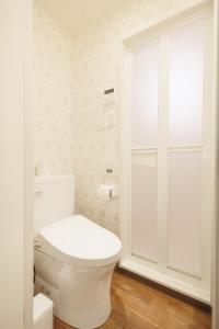 a white bathroom with a toilet and a glass door at Hotaku HOTEL - Vacation STAY 98852v in Tokyo