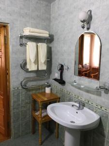 a bathroom with a sink and a mirror at Emir in Bukhara