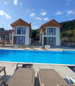 a large swimming pool in front of a house at Belvedere in Ambrolauri