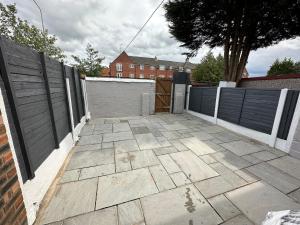 a patio with a fence and a wooden gate at MMC Serviced accommodation in Leigh
