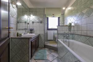 a bathroom with a tub and a sink at Villa Maria Antonietta in Sassari +16 photos