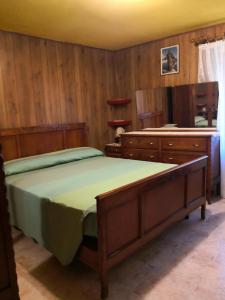 a bedroom with a large bed and wooden cabinets at Appartamenti Rio Geandola 