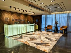 a lobby of a hotel with a reception desk at Wyndham Hotel Melbourne in Melbourne