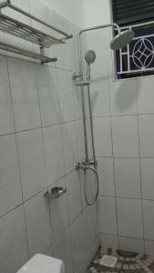 a shower stall with a toilet in a bathroom at Fort Marigold Hotel in Fort Portal