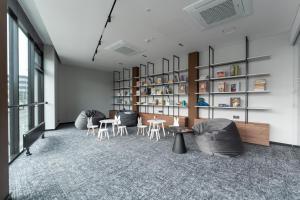 a room with two chairs and a table and shelves at Pan Tadeusz in Vilnius