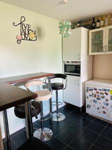 a kitchen with a table and chairs and a refrigerator at DARTFORD CROSSING The BRIDGE PLACE - CONTRACTORS FAVOURITE in Kent