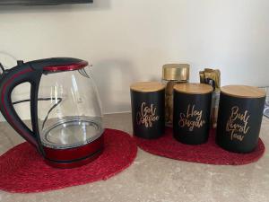 a blender on a red rug next to three cups at Big room in Stellenbosch in Stellenbosch
