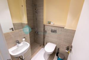 a bathroom with a shower and a toilet and a sink at Classic 2 Bedroom In Oasis in Al Qurayyah