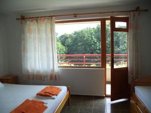 a bedroom with a bed and a large window at Victoria Sinemorets Guest House in Sinemorets