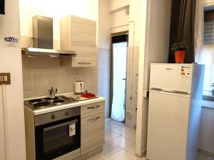 a kitchen with a refrigerator and a stove top oven at Pero Apartment - Fiera Milano in Pero